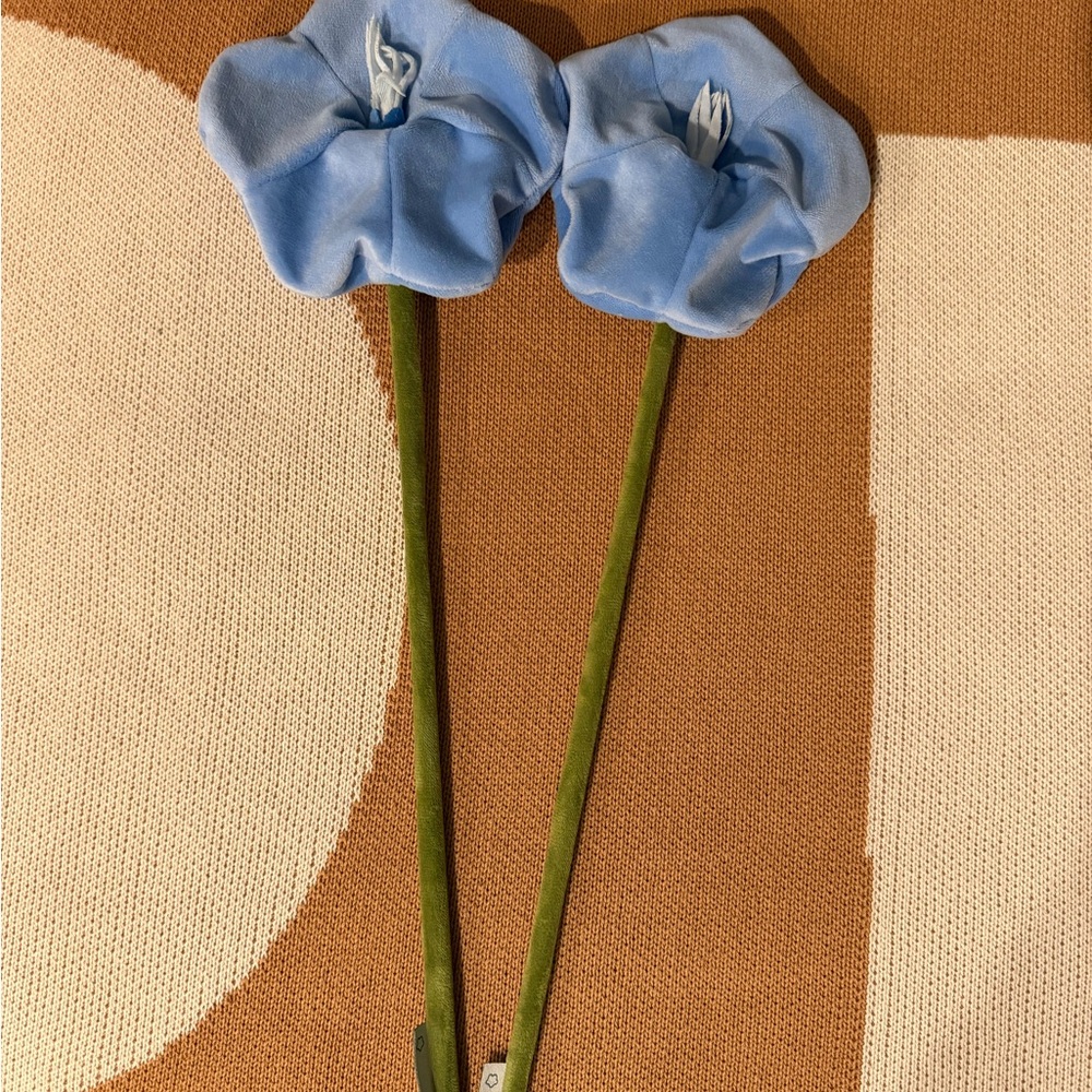 Two blue plushie flowers by CJ Hendry